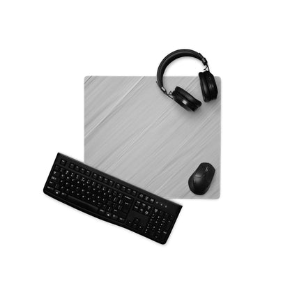Black wireless keyboard on brushed aluminum large gaming mouse pad