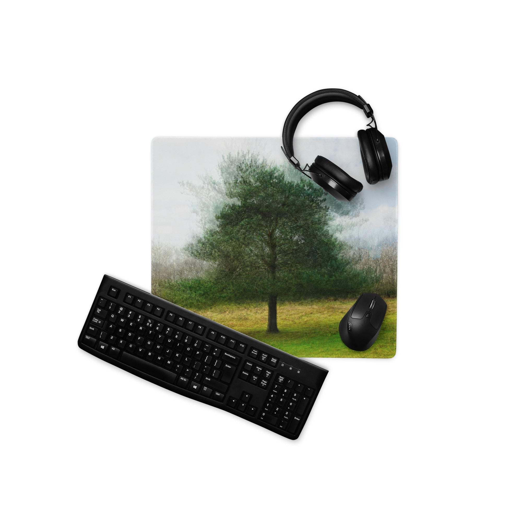 Black ergonomic wireless mouse on nature-inspired tree landscape gaming mouse pad