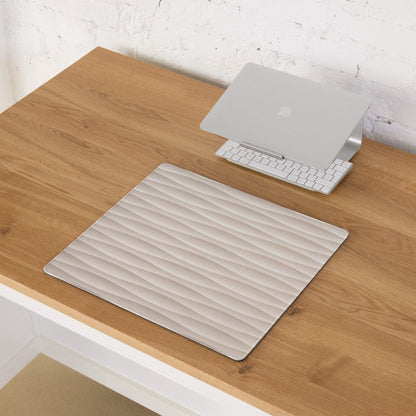 Silver laptop stand on cream beige wave textured gaming mouse pad