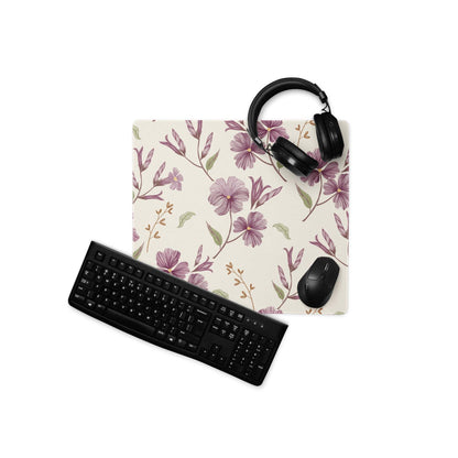 Beige purple floral gaming mouse pad with headphones on top