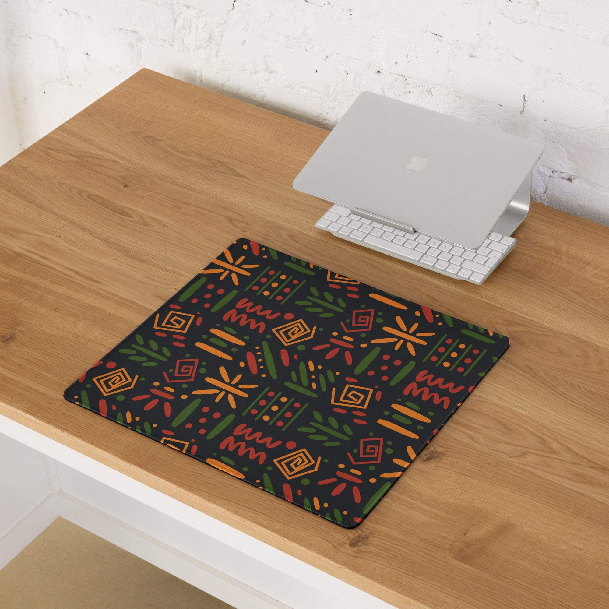 Black gaming mouse pad with vibrant orange green geometric botanical pattern