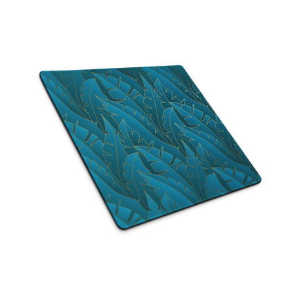 Teal tropical leaf gaming mouse pad with gold outlines and non-slip base