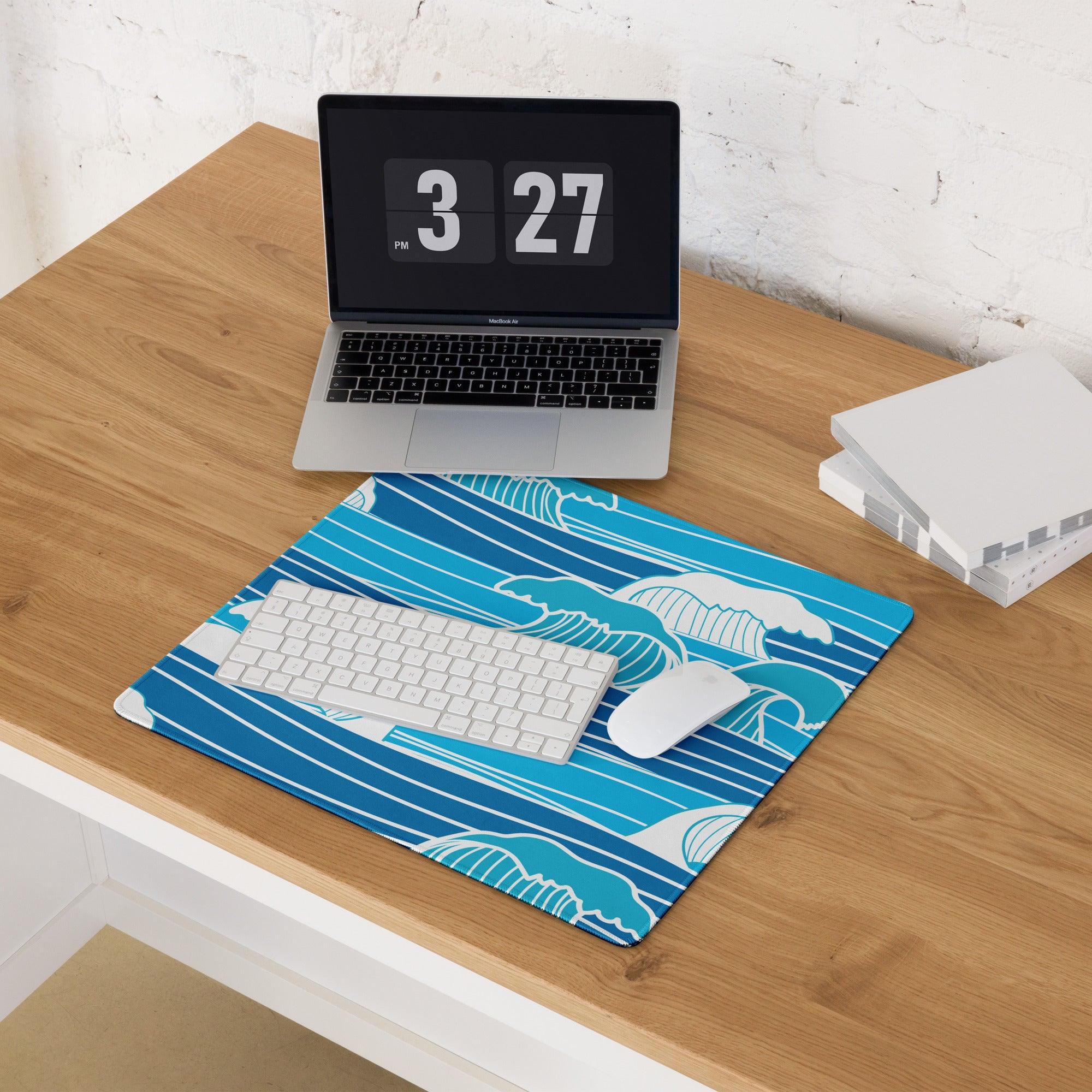 Blue wave-patterned gaming mouse pad with white accents and stitched edges