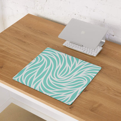 Large teal leaf-patterned gaming mouse pad with stitched non-slip edges