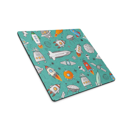 Teal space-themed gaming mouse pad with rockets, astronauts, planets, non-slip base