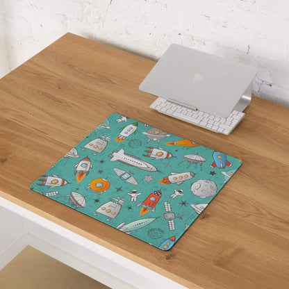 Teal space-themed gaming mouse pad with rockets, astronauts, non-slip base