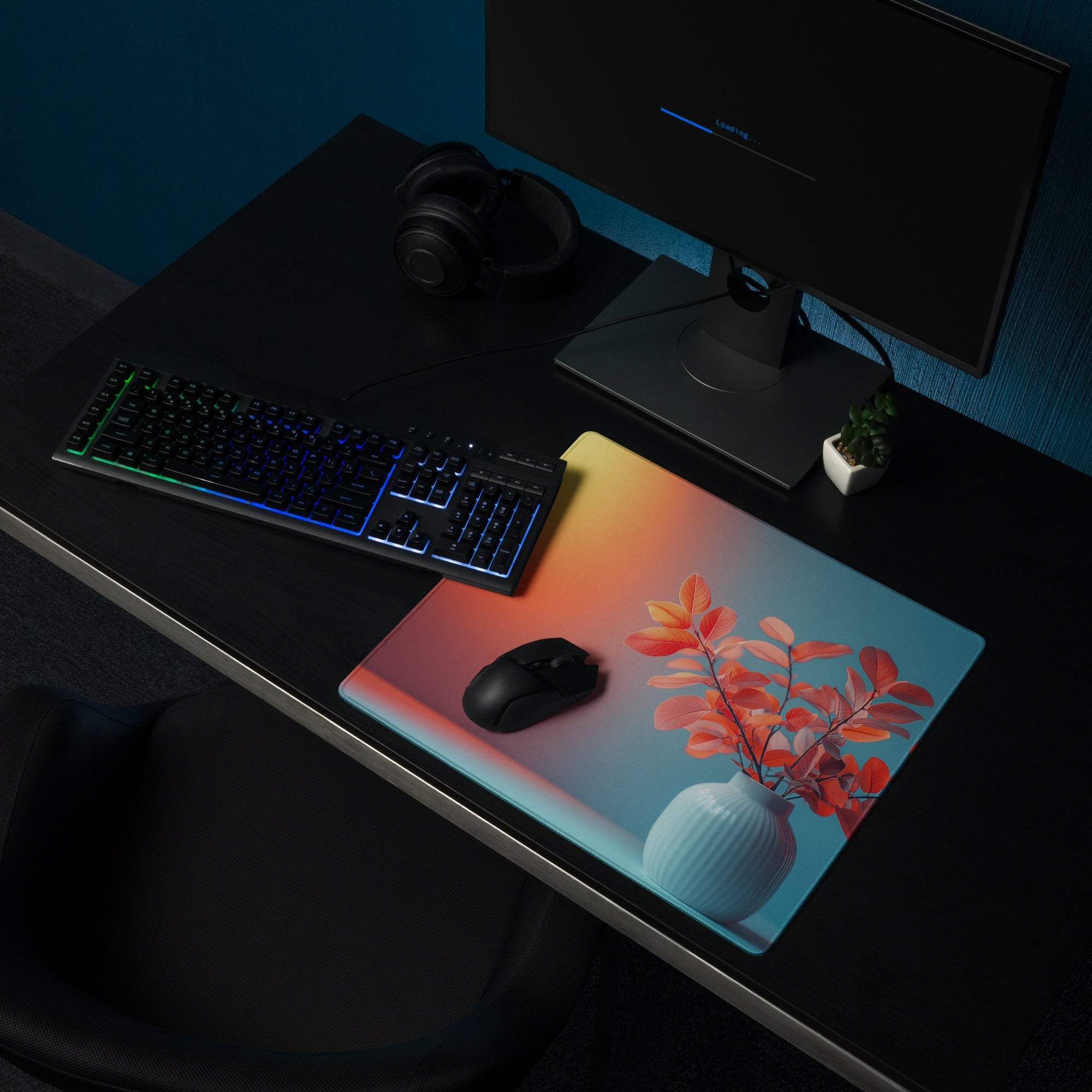 Vibrant gradient gaming mouse pad with orange-to-blue fade, leaf vase art