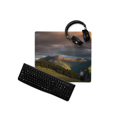 Black keyboard mouse on epic mountain sunset gaming mousepad with headphones