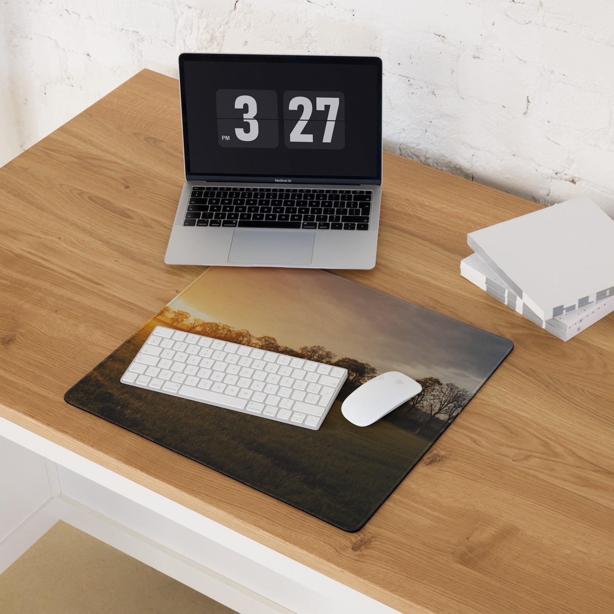 Golden Hour Sunset gaming mouse pad with silhouetted trees on wood desk
