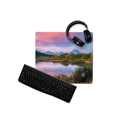 Vibrant mountain sunrise mouse pad with black headphones on top