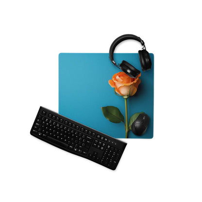 Elegant blue rose gaming mousepad with orange rose design, headphones, mouse
