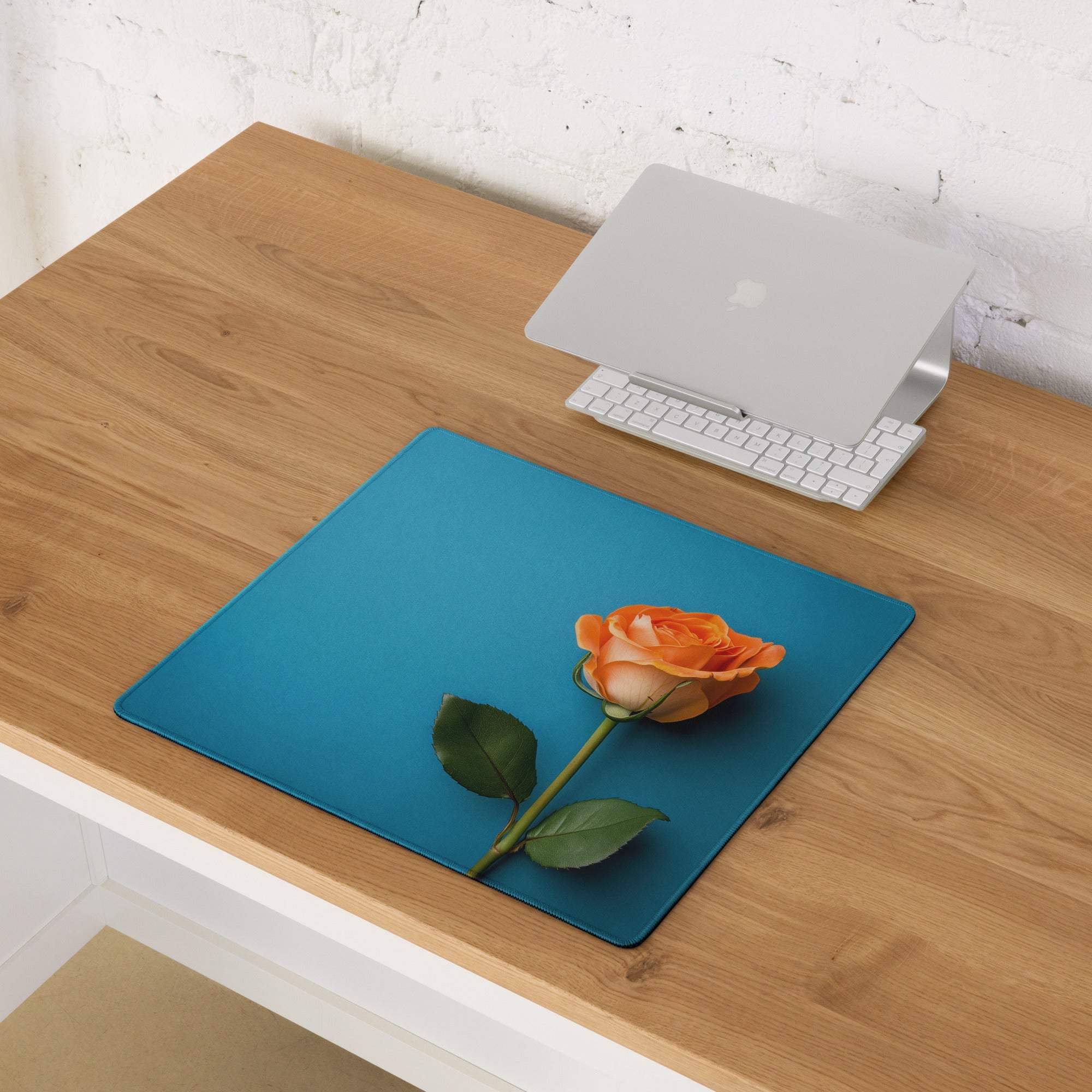 Elegant blue gaming mouse pad with orange rose, green stem, non-slip backing
