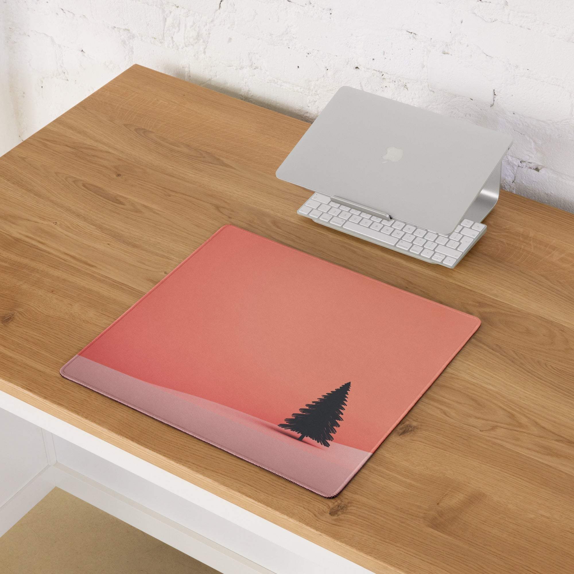 Pink laptop sleeve with black pine tree on sunset gradient, minimalist design