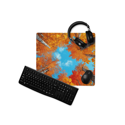 Autumn forest gaming mouse pad with vibrant orange foliage and blue sky