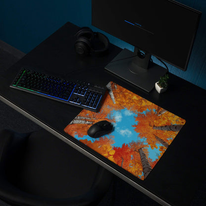 Autumn forest gaming mouse pad with vibrant orange foliage and blue sky