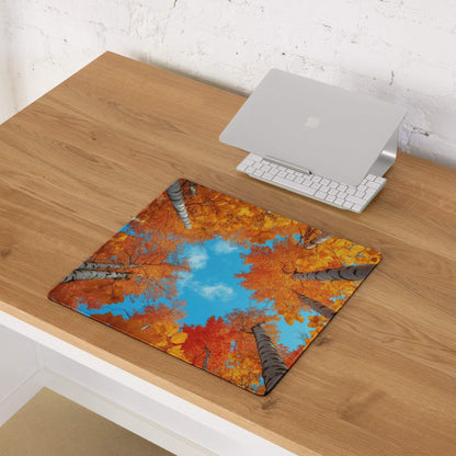 Autumn forest gaming mouse pad with vibrant orange foliage on desk