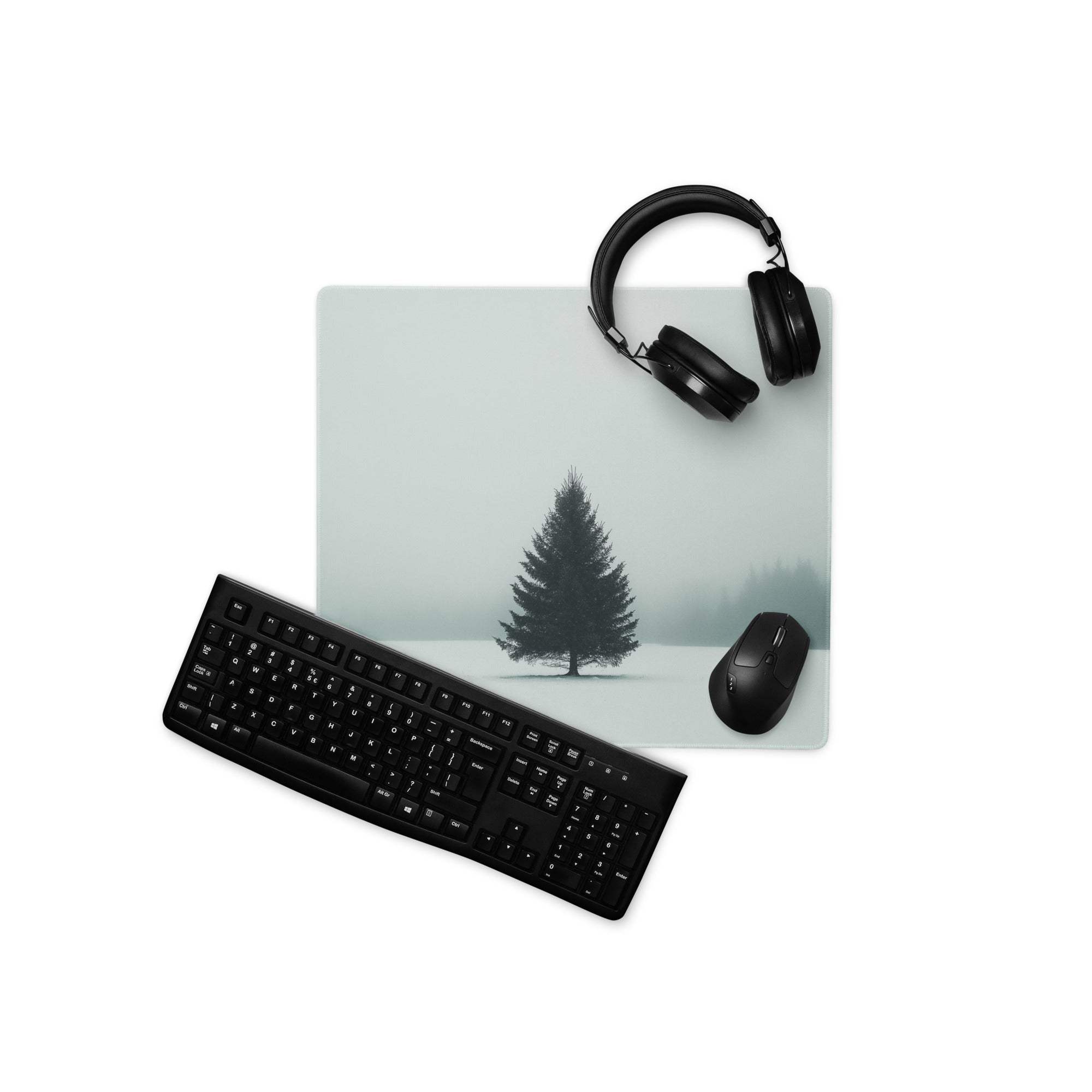 Minimalist snowy evergreen tree on misty green gaming mouse pad