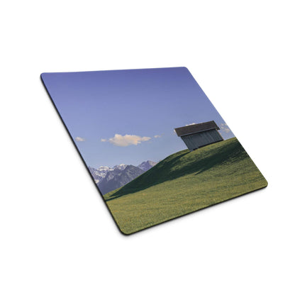 Scenic rustic shed on green hillside mouse pad, calm sky blue gaming style