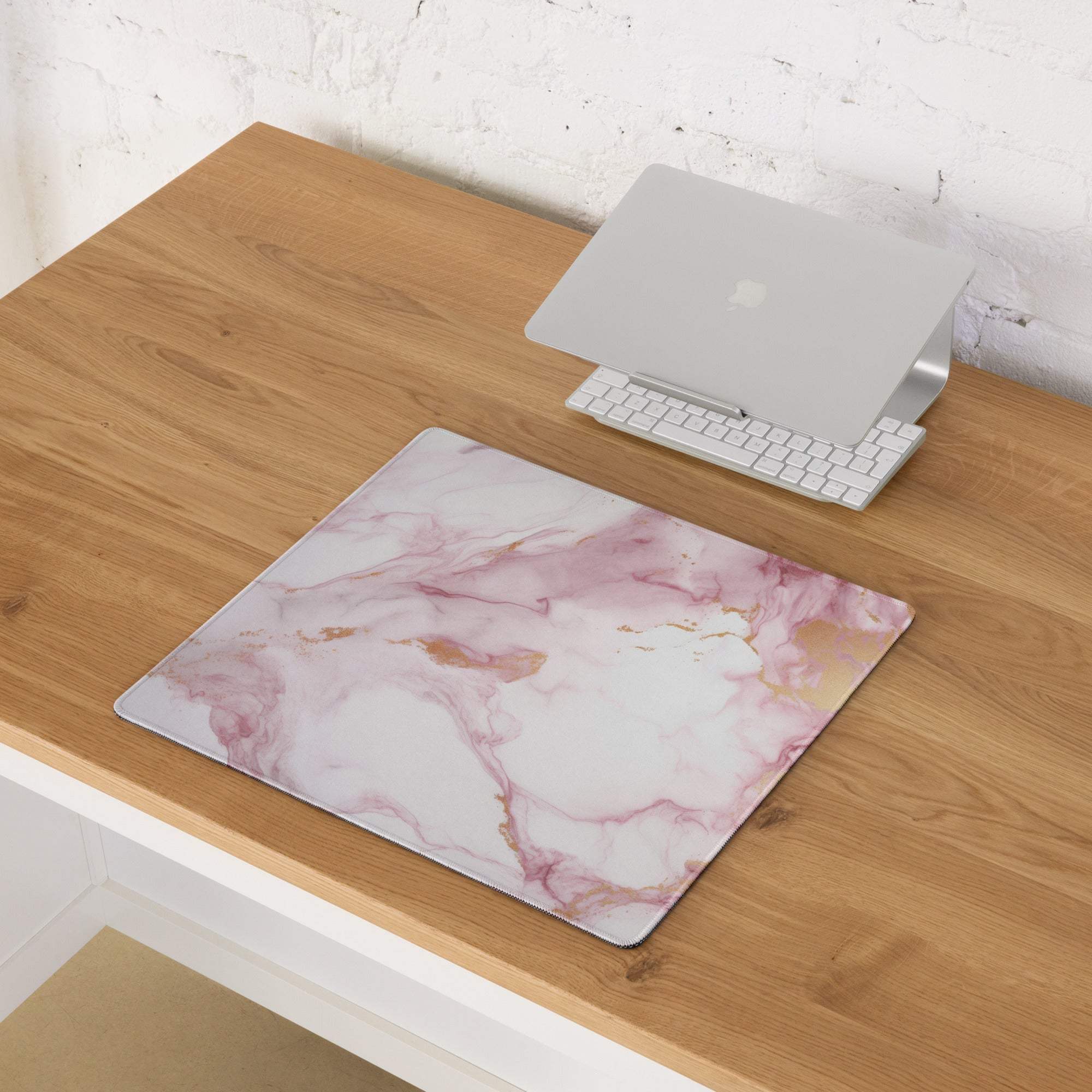 Elegant pink marble gaming mouse pad with gold veins on wooden desk