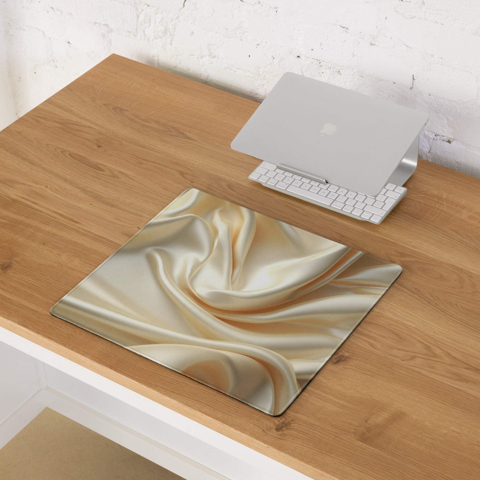 Elegant satin gold gaming mouse pad with glossy flowing design and non-slip backing