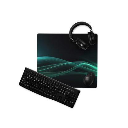 Sleek teal wave on black gaming mouse pad with keyboard headset setup