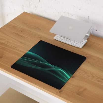 Sleek teal wave on black gaming mouse pad with non-slip edge stitching