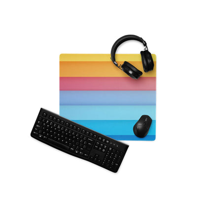 Large rainbow gradient gaming mouse pad with black keyboard and headphones