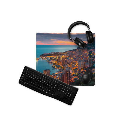 Black keyboard and mouse on coastal city sunset gaming mousepad
