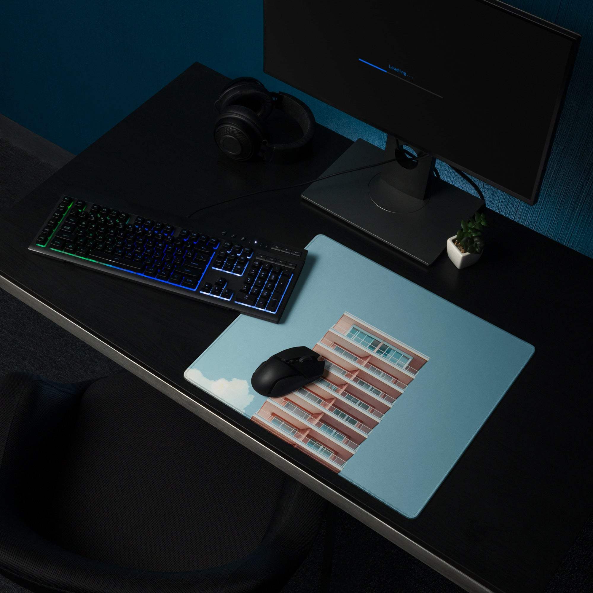 Light blue gaming mouse pad with pinkish-red brick building print