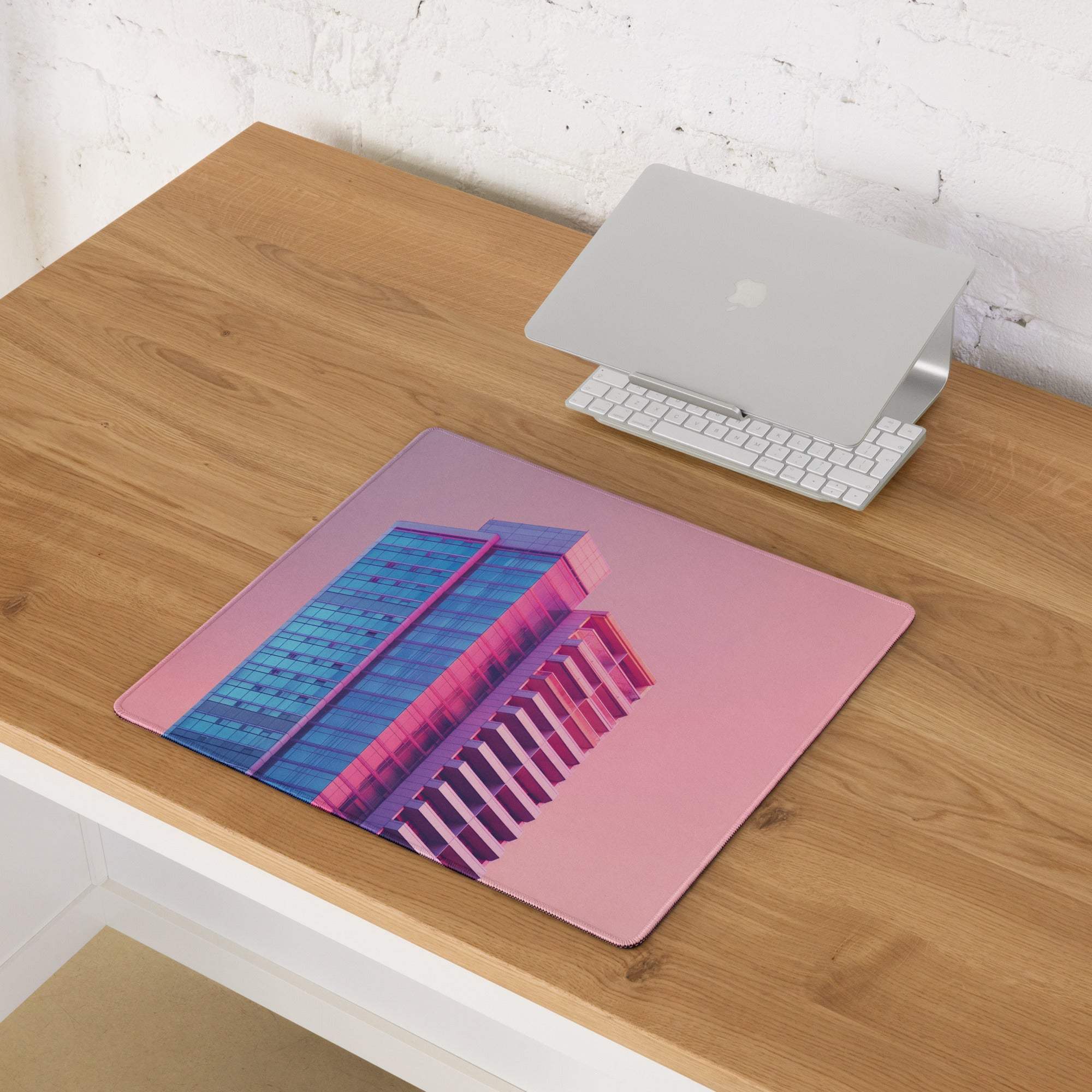 Neon pink gradient cityscape gaming mouse pad with pink blue building graphic