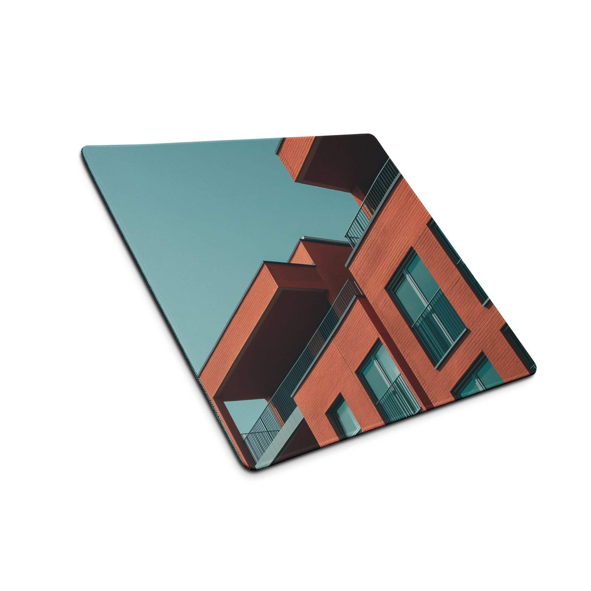 Sleek large edge-stitched gaming mouse pad with teal brick buildings design