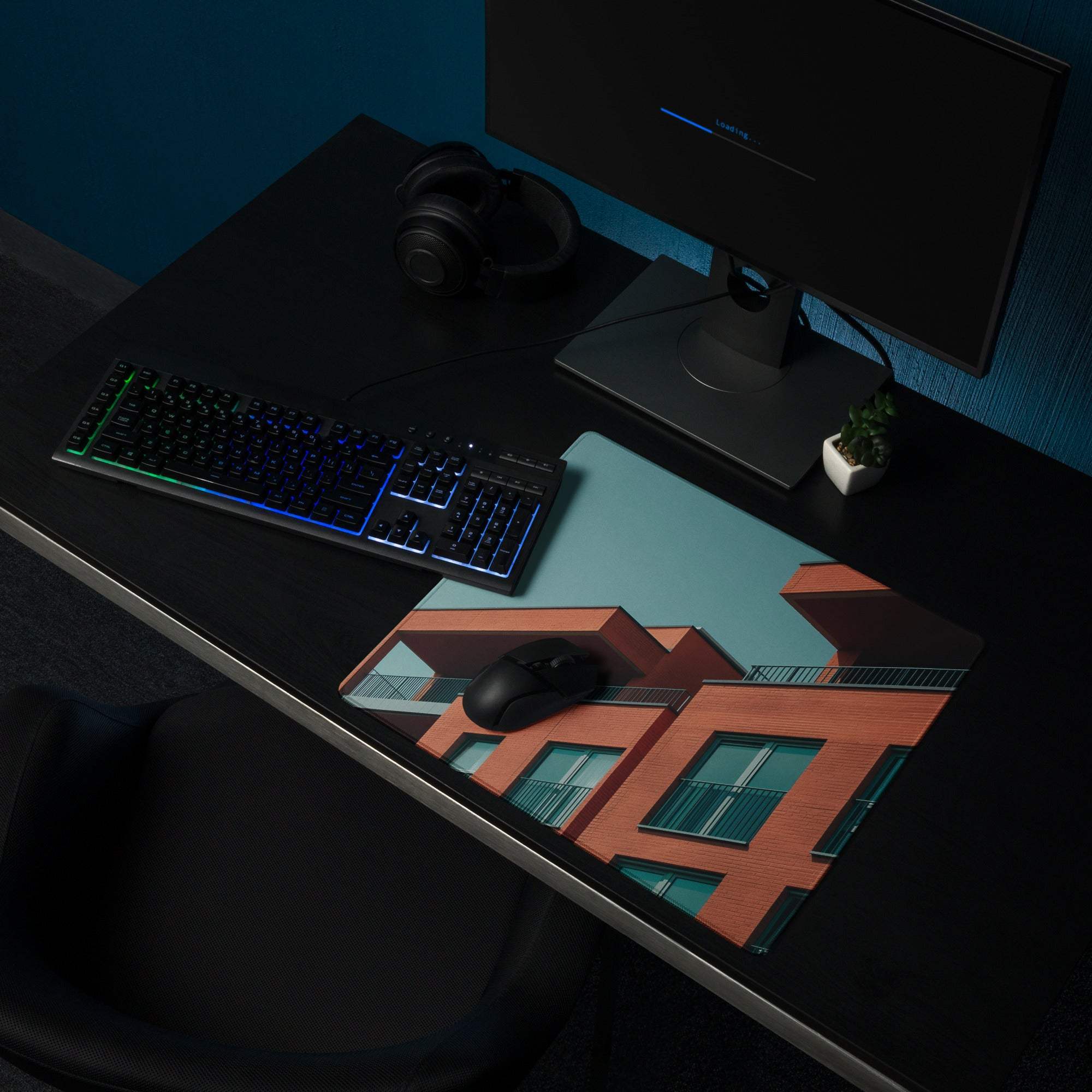 Sleek large edge-stitched gaming mouse pad with orange teal brick buildings design