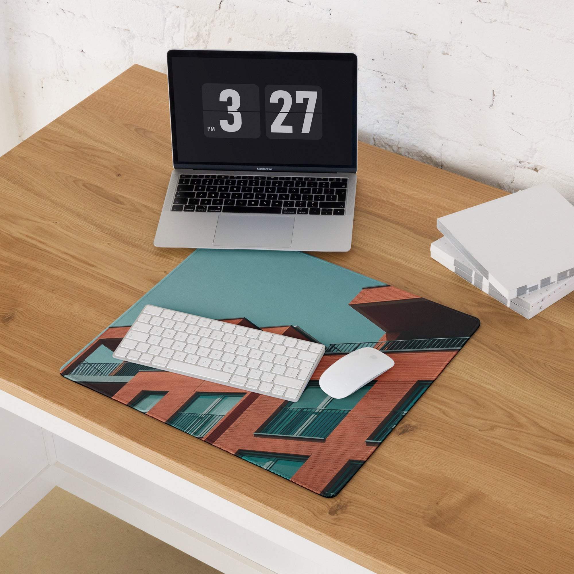 Sleek large edge-stitched gaming mouse pad with orange brick architecture on teal background