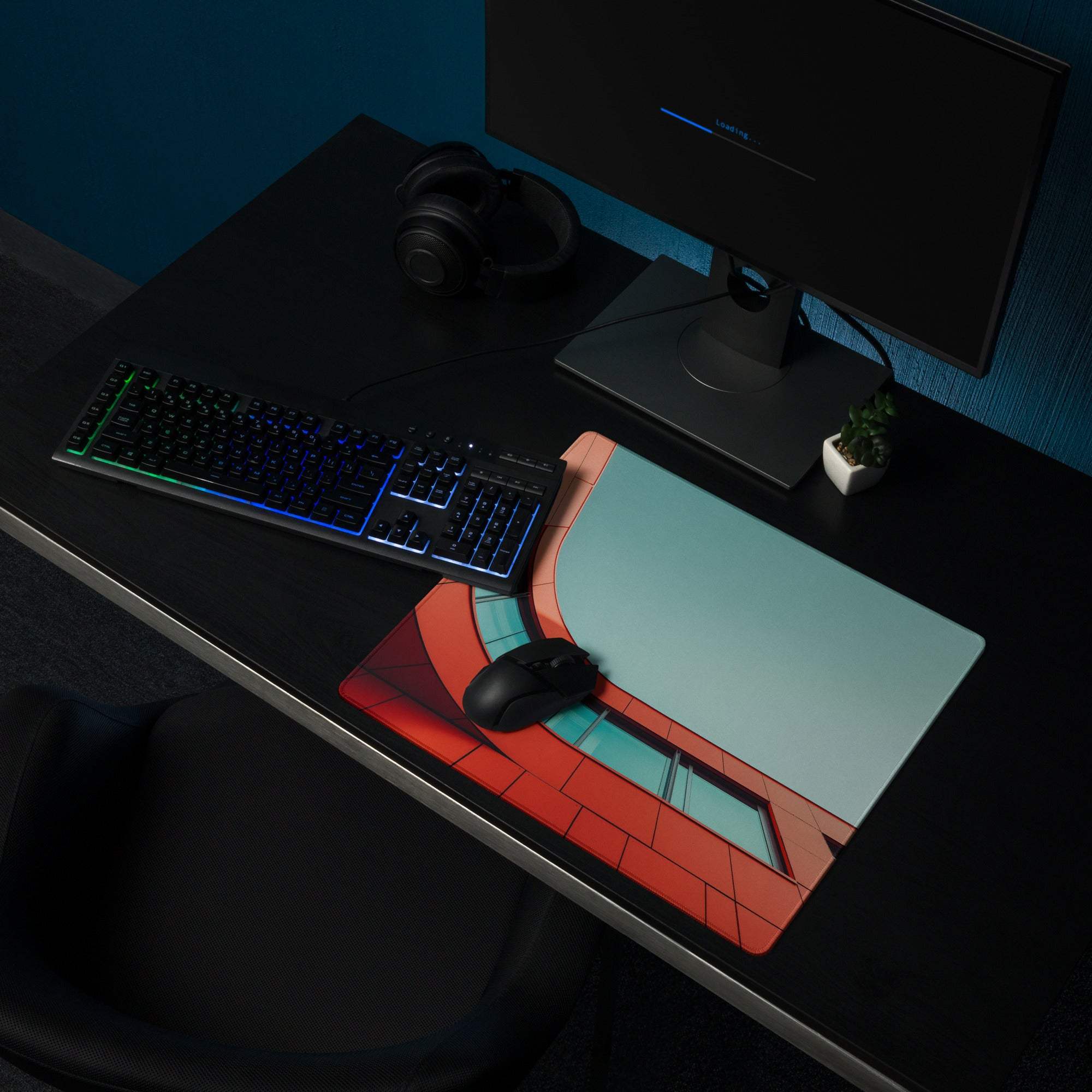 Bold orange-red architectural curve gaming mouse pad with brick design on desk