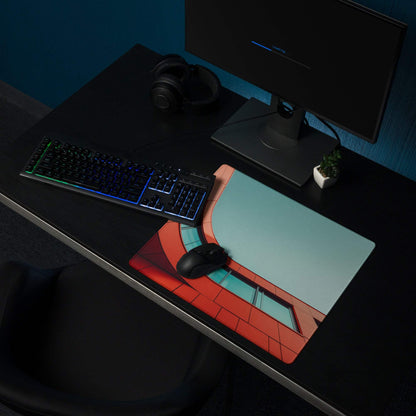 Bold orange-red architectural curve gaming mouse pad with brick design on desk