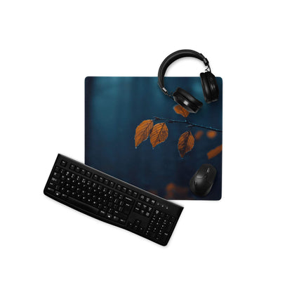 Large moody night scene gaming mouse pad with deep blue orange leaf design, headphones, keyboard