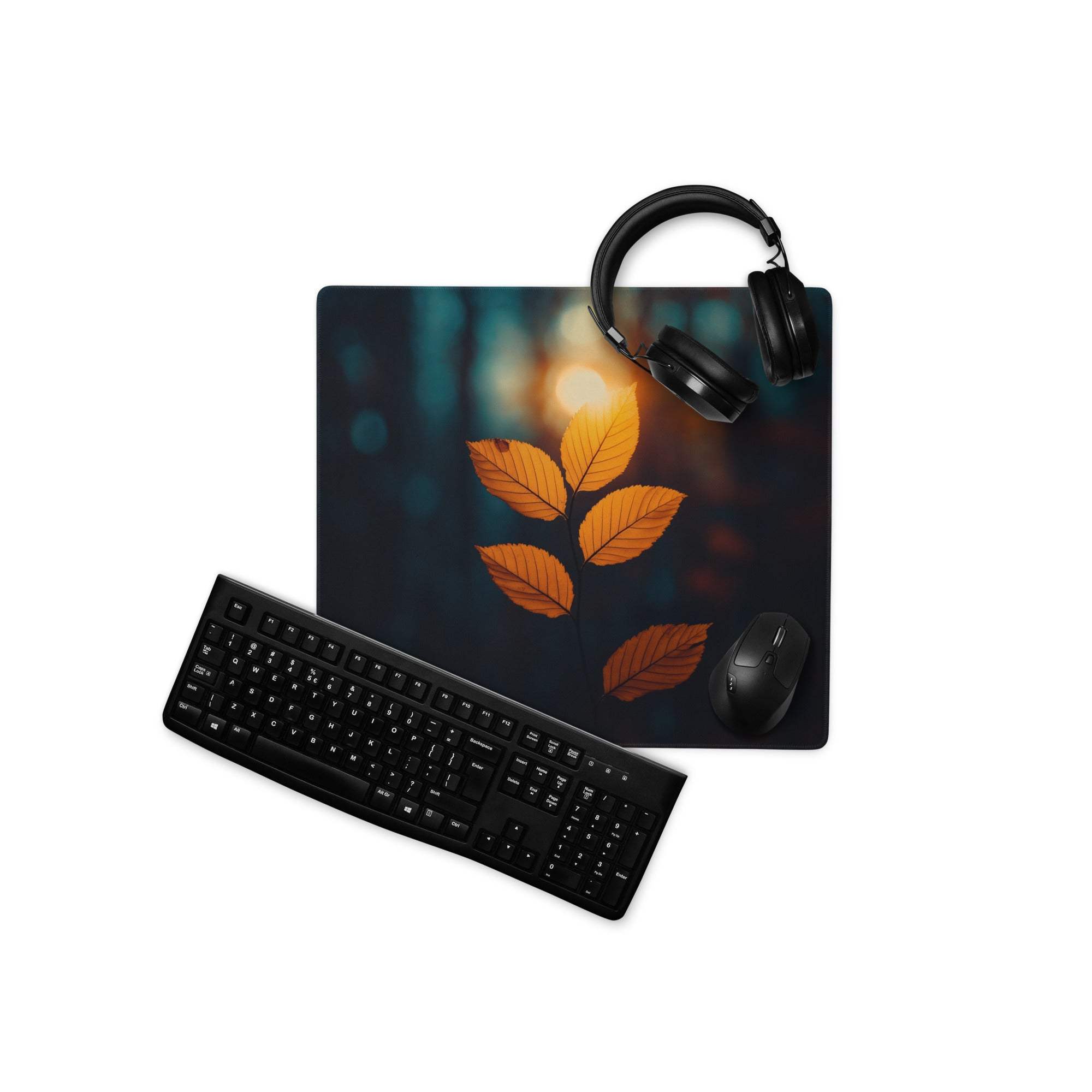 Large autumn leaf gaming mouse pad with orange glow, headphones on top