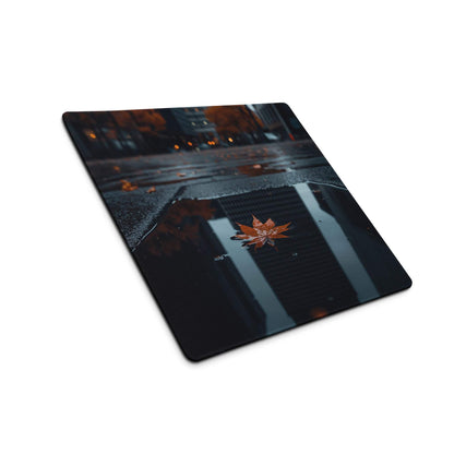 Sleek black Moody Urban Night large gaming mousepad with glossy orange maple leaf in rain puddle
