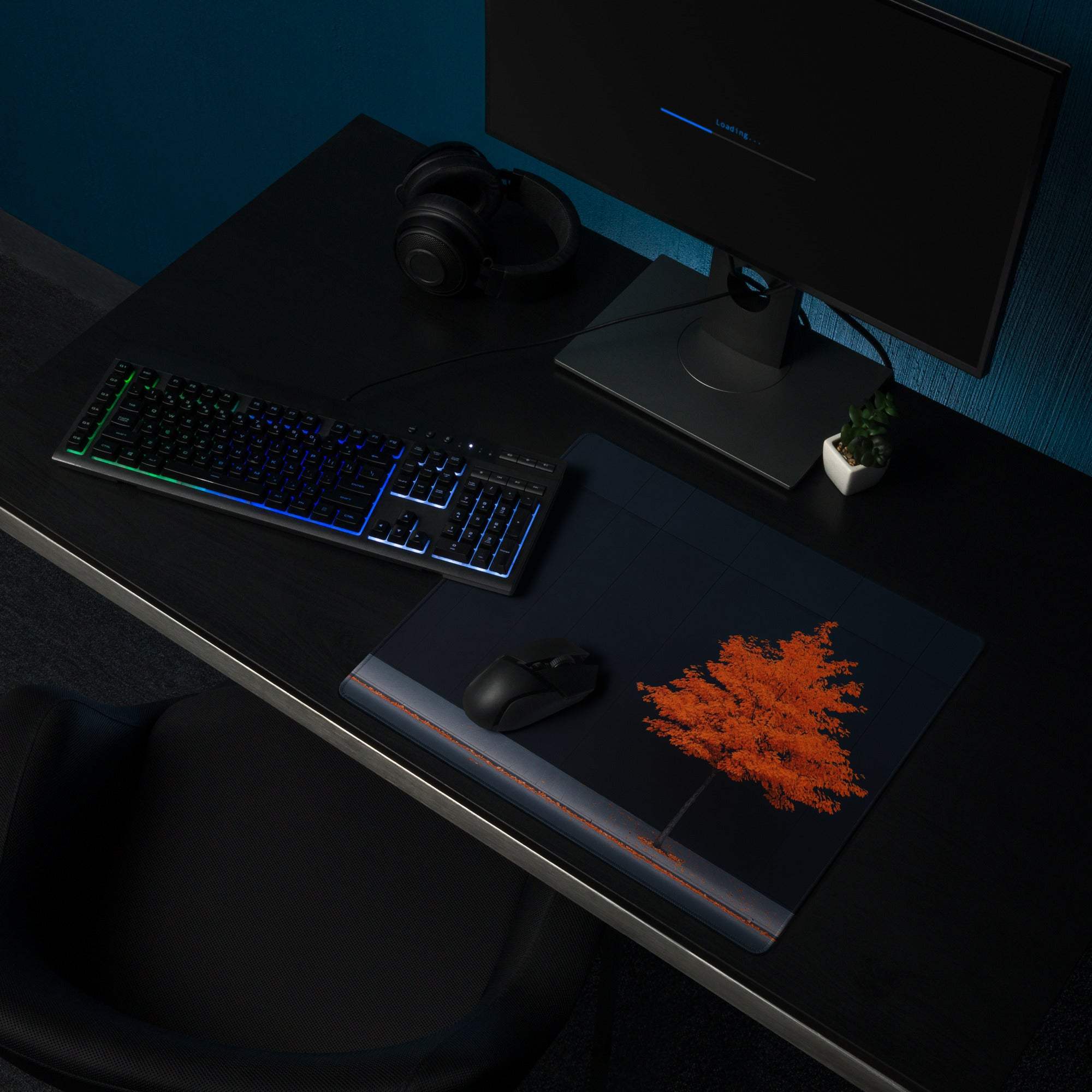 Black gaming mousepad with orange tree design, red edge stitching
