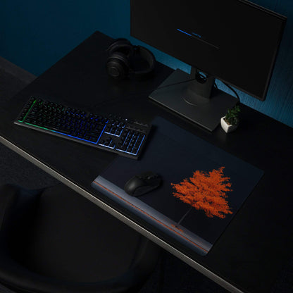 Black gaming mousepad with orange tree design, red edge stitching