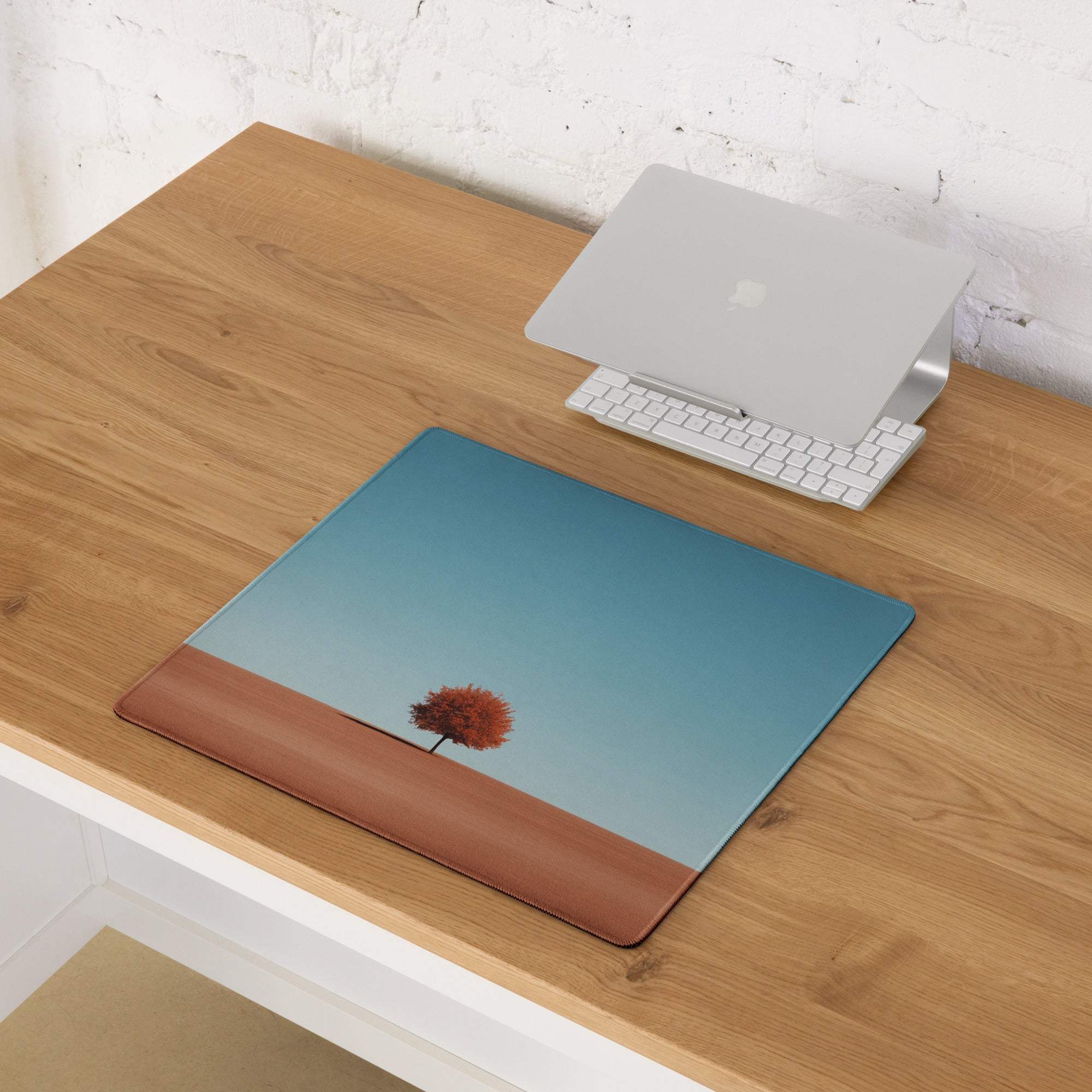 Minimalist orange tree on blue gradient laptop sleeve with leather border