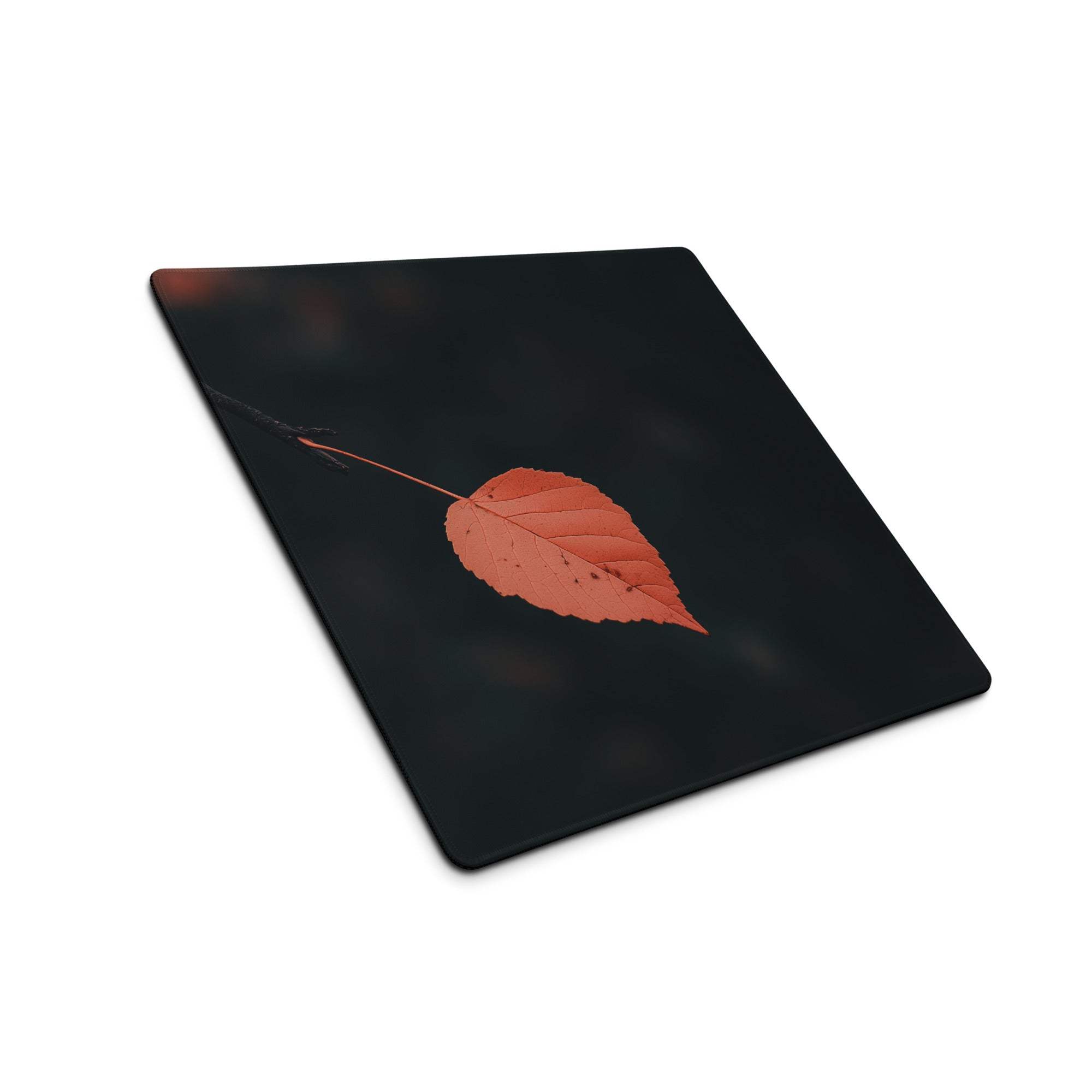 Black rectangular cutting board with orange leaf design on gaming mouse pad
