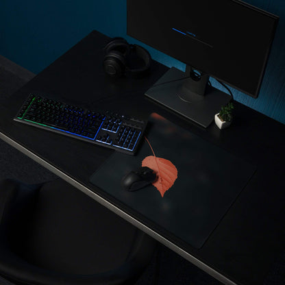Black minimalist leaf gaming mouse pad with orange leaf design, non-slip base, stitched edges