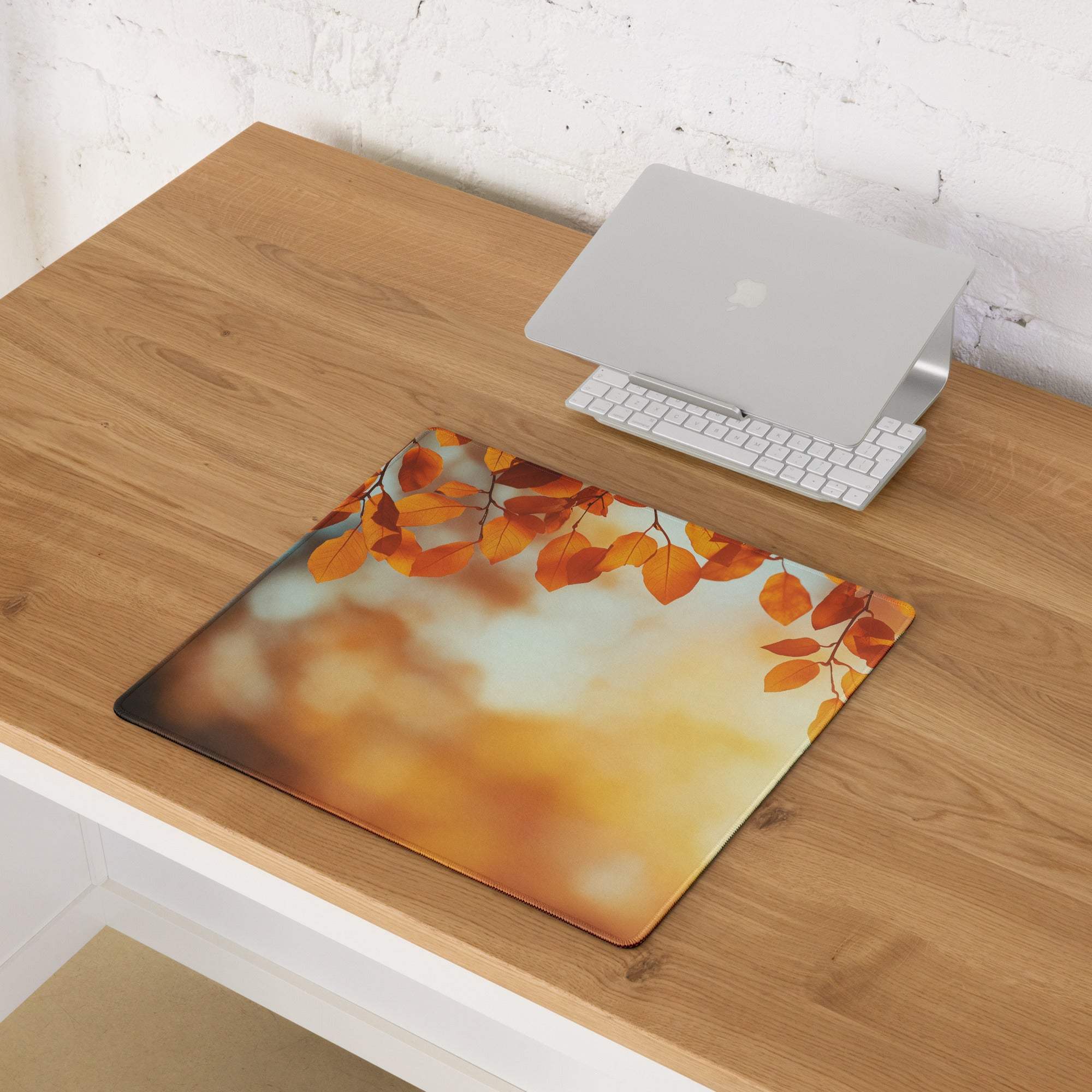 Autumn leaves gaming mouse pad with orange sunset design, large non-slip stitched edges