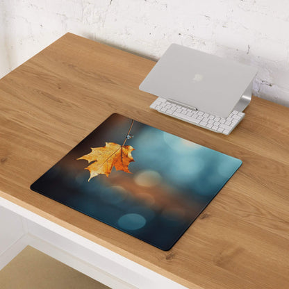 Autumn leaf gaming mouse pad with warm orange yellow tones on desk