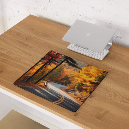 Vibrant autumn forest road gaming mouse pad with orange foliage, non-slip stitched edges