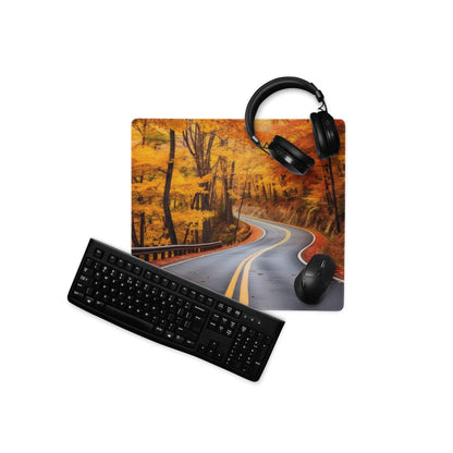 Black keyboard and mouse on vivid autumn forest road gaming mouse pad