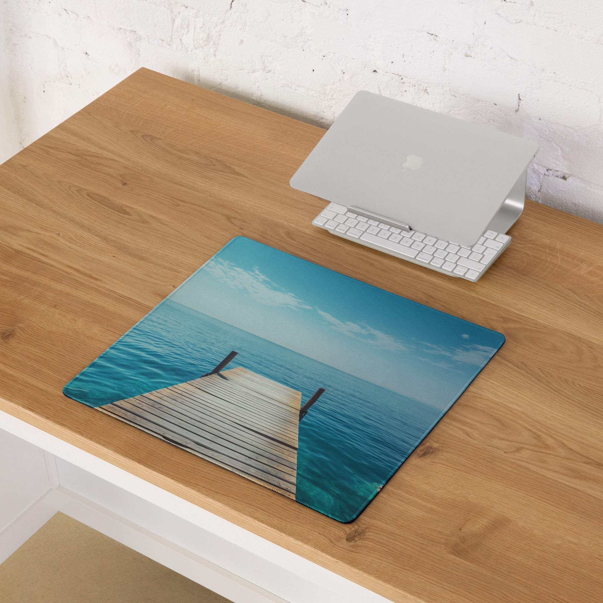 Calm ocean dock scene gaming mouse pad with pier, turquoise water, non-slip backing