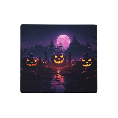 Halloween pumpkin purple gaming desk pad featuring glowing orange jack o lanterns and a purple moon over haunted houses