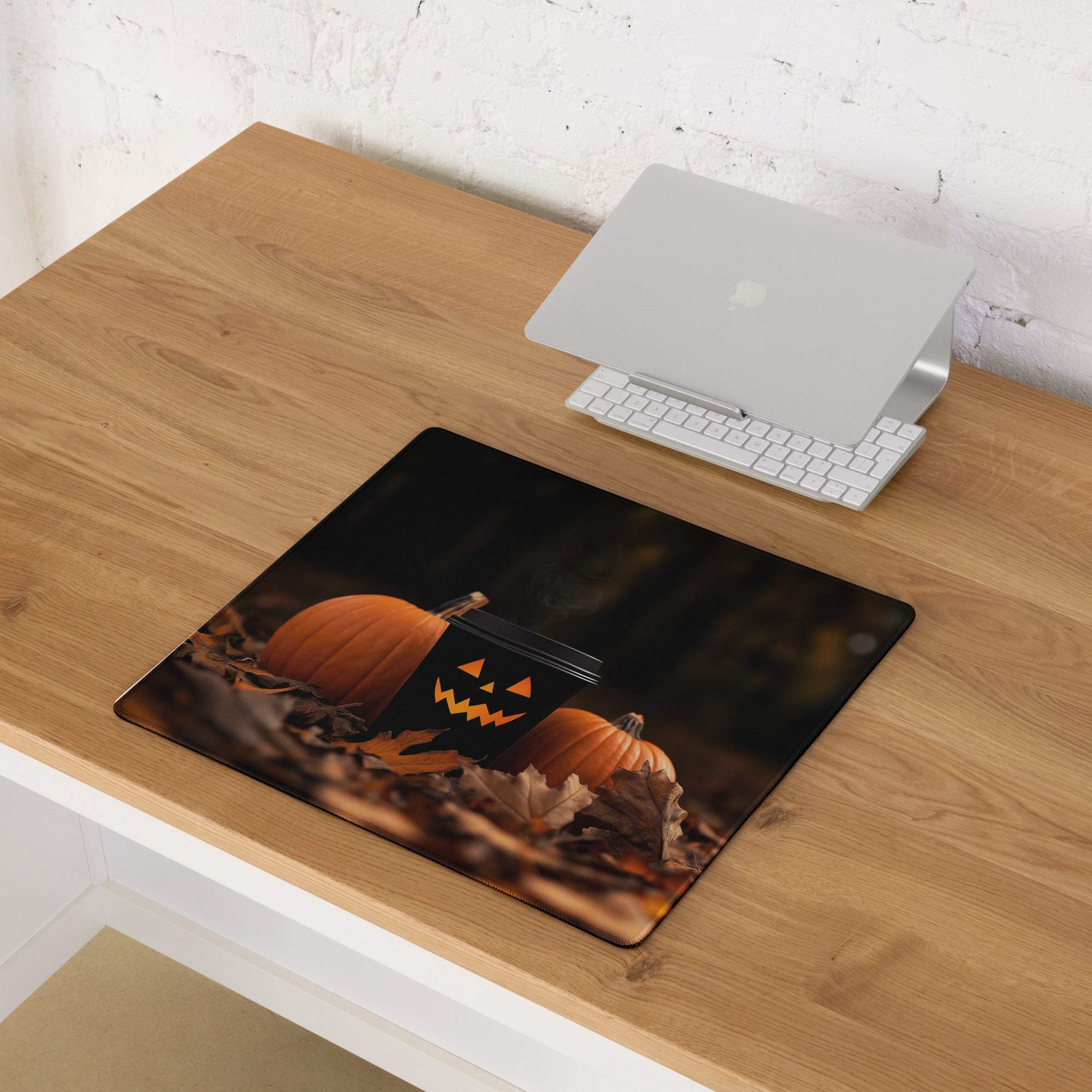 Halloween gaming mousepad with black background, orange pumpkins, jack-o-lantern mug
